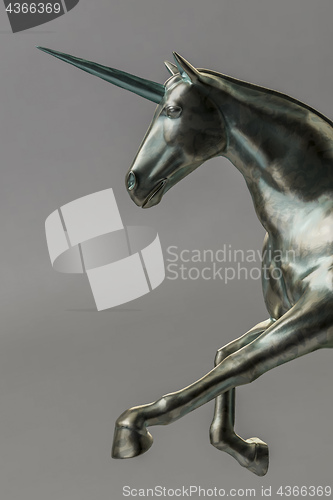 Image of a beautyful bronze unicorn figure isolated on gray background