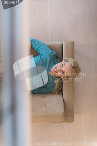 Image of woman on sofa using tablet computer