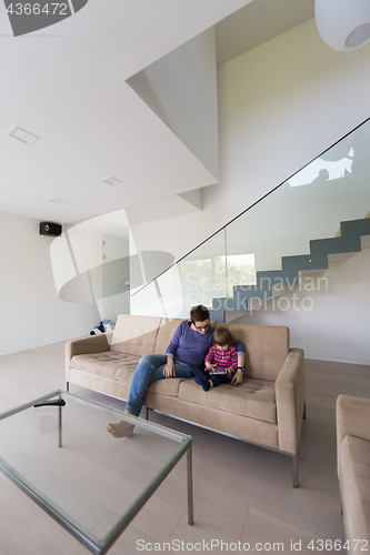 Image of mother and her cute little daughter are using a tablet