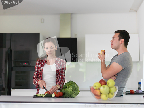 Image of Young handsome couple in the kitchen