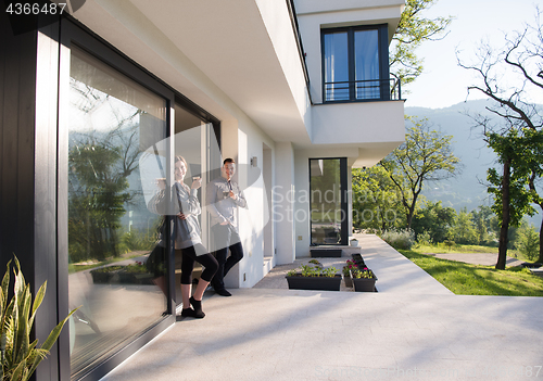 Image of couple enjoying on the door of their luxury home villa