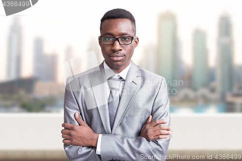 Image of Young black businessman in front of the big city