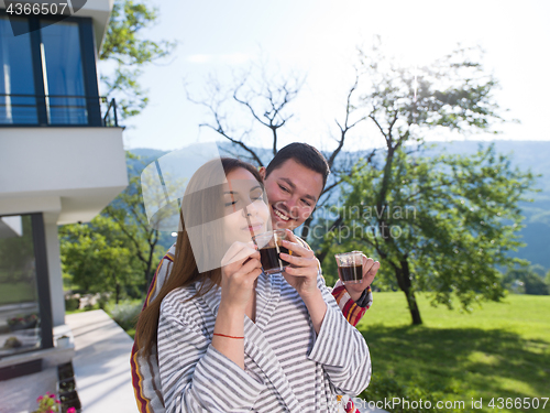 Image of Young beautiful couple in bathrobes