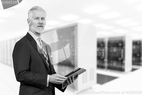 Image of Senior businessman in server room