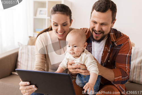 Image of mother, father and baby with tablet pc at home