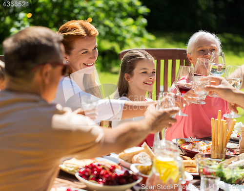 Image of happy family having dinner or summer garden party