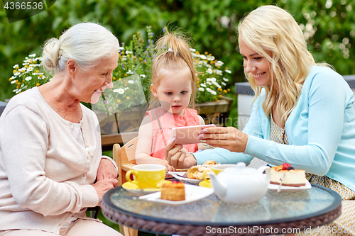 Image of happy family taking selfie at cafe