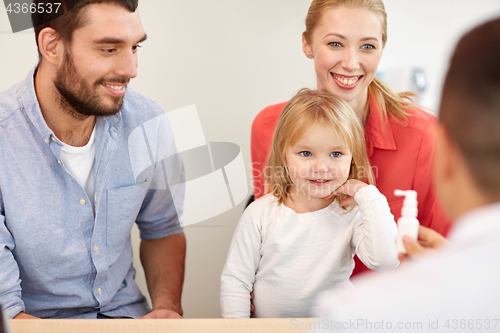 Image of happy family with daughter and doctor at clinic