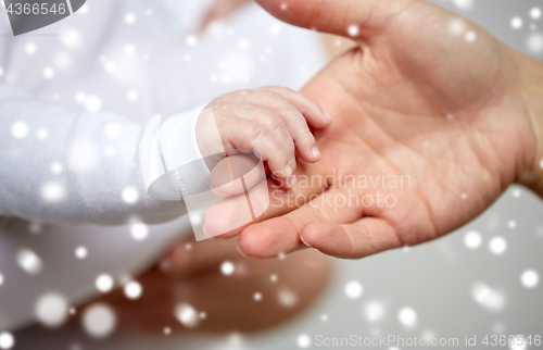 Image of close up of mother and newborn baby hands