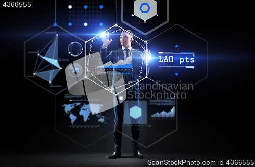 Image of businessman working with charts on virtual screen