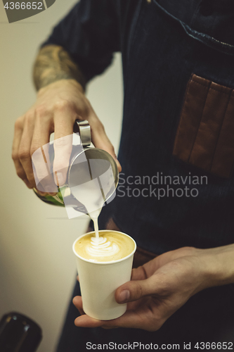 Image of Bartender pouring coffee to cup