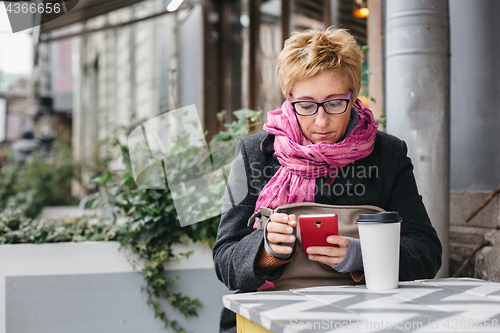 Image of Adult woman surfing phone