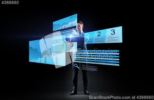 Image of businessman with stock charts on virtual screens