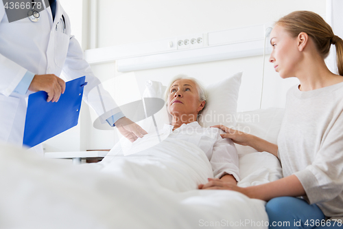 Image of senior woman and doctor with clipboard at hospital