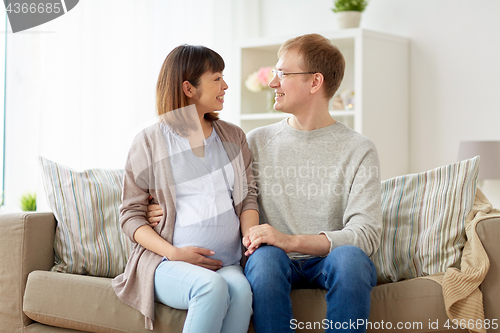 Image of happy pregnant wife with husband at home