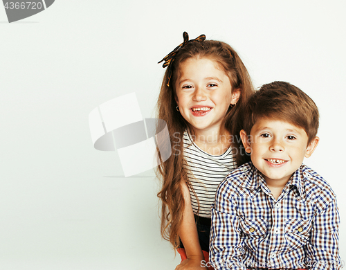 Image of little cute boy and girl hugging playing on white background