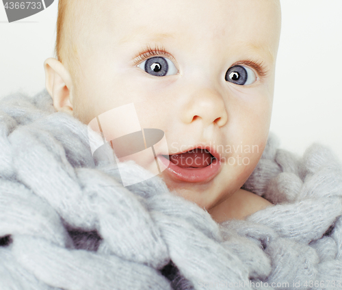 Image of little cute red head baby in scarf all over him close up isolated