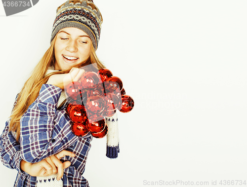 Image of young pretty blond teenage girl in winter hat and scarf on white background smiling