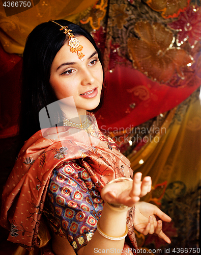 Image of beauty sweet real indian girl in sari smiling on black background