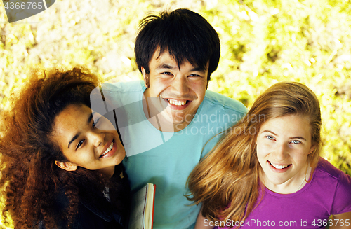 Image of cute group teenages at the building of university with books huggings, diversity nations