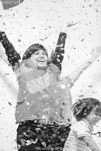 Image of kids  blowing confetti