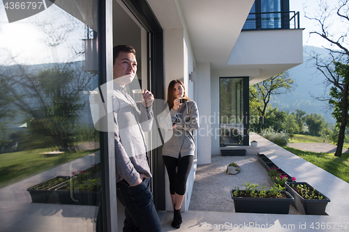 Image of couple enjoying on the door of their luxury home villa
