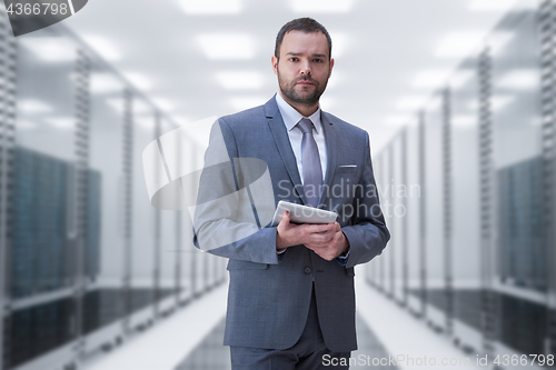 Image of Young businessman in server room