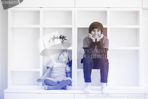 Image of young boys posing on a shelf