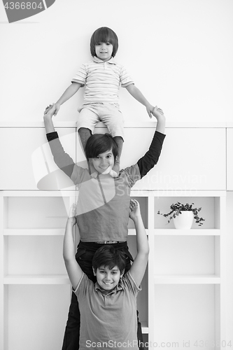 Image of young boys posing line up piggyback