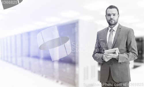 Image of Young businessman in server room