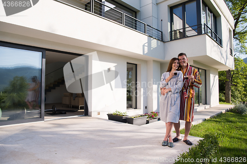 Image of Young beautiful couple in bathrobes