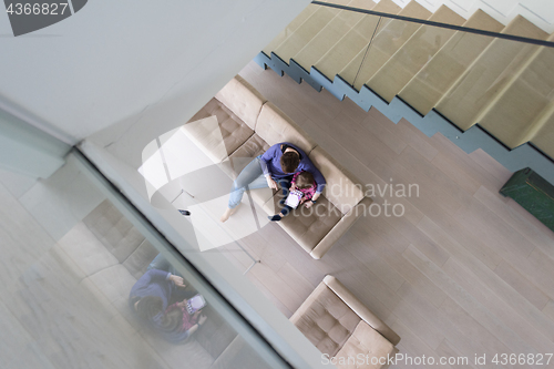 Image of mother and her cute little daughter are using a tablet top view