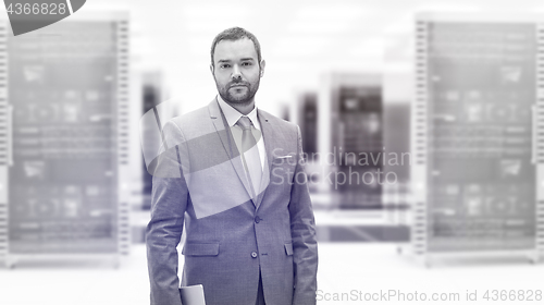 Image of Young businessman in server room