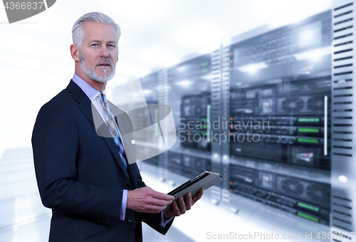 Image of Senior businessman in server room