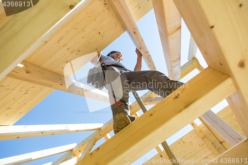 Image of Builders at work with wooden roof construction.