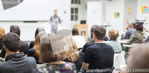 Image of Man giving presentation in lecture hall at university.