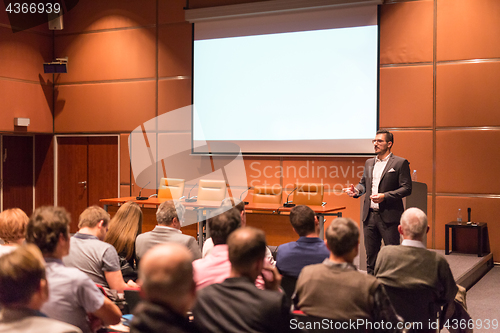 Image of Business speaker giving a talk at business conference event.