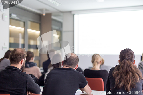 Image of Audience in the lecture hall listening to academic presentation.