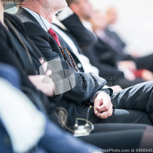 Image of Row of business people sitting at seminar.