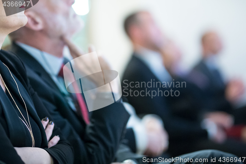 Image of Row of business people sitting at seminar.