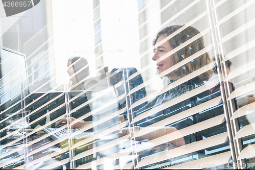 Image of Yound devoted female software developers team working on desktop computer in IT statup company.