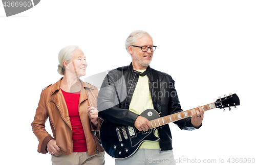 Image of happy senior couple with electric guitar