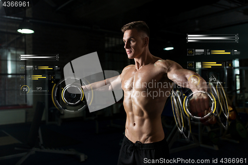 Image of close up of man with dumbbells exercising in gym