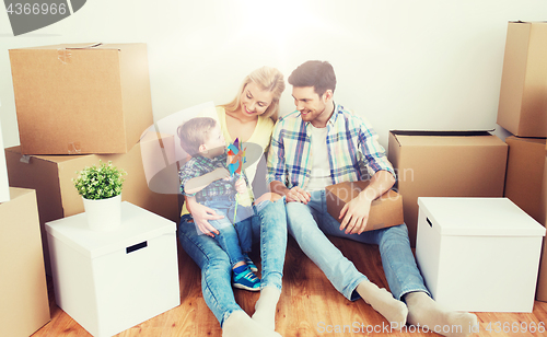 Image of happy family with boxes moving to new home