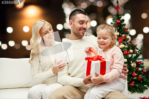 Image of happy family at home with christmas gift box