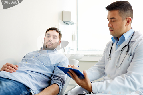 Image of doctor and man with health problem at hospital