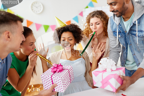 Image of team greeting colleague at office birthday party