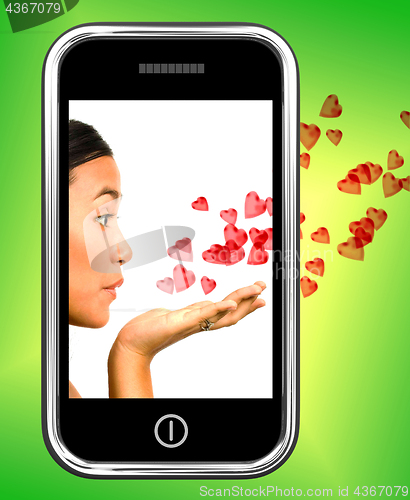 Image of Girl Blowing Hearts From A Mobile Phone