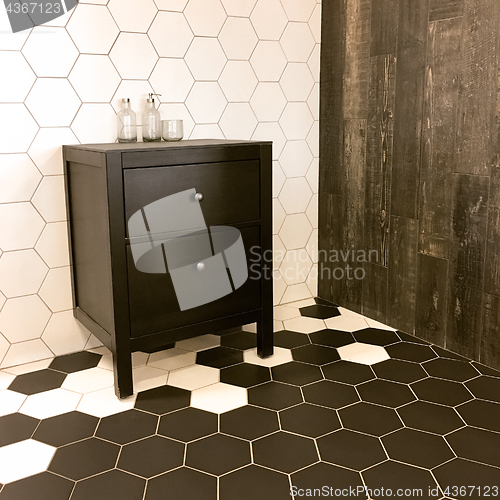 Image of Spacious bathroom with tiled floor and black drawer unit