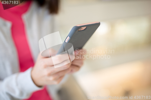 Image of Woman browsing cellphone